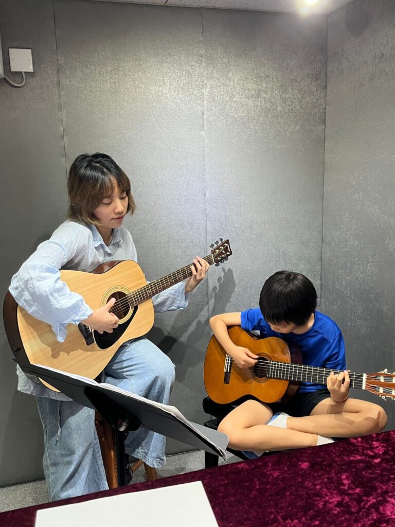 This is Elyse Ho, she's having a guitar lesson with her student. Get ready for the exam!