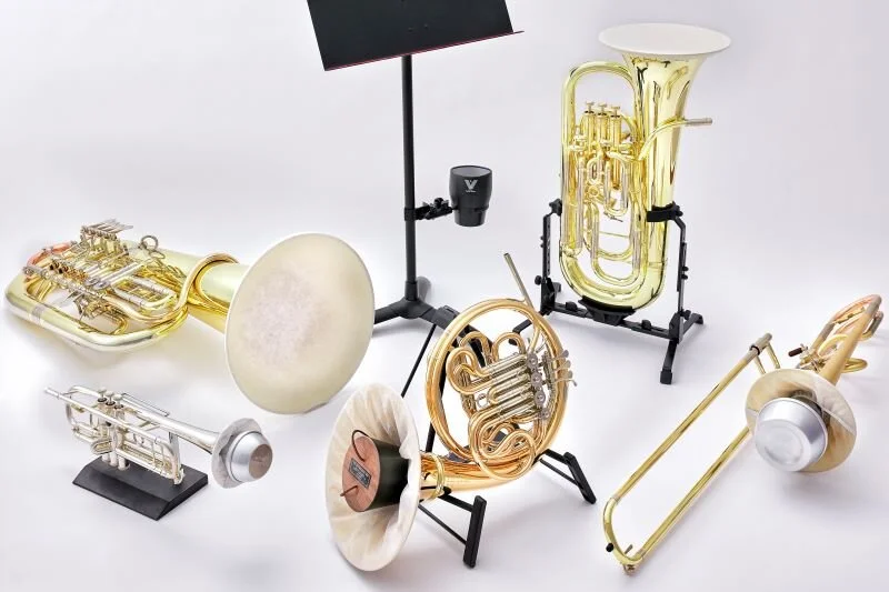 This is a photo with several brass instruments, like French horn, euphonium, etc.